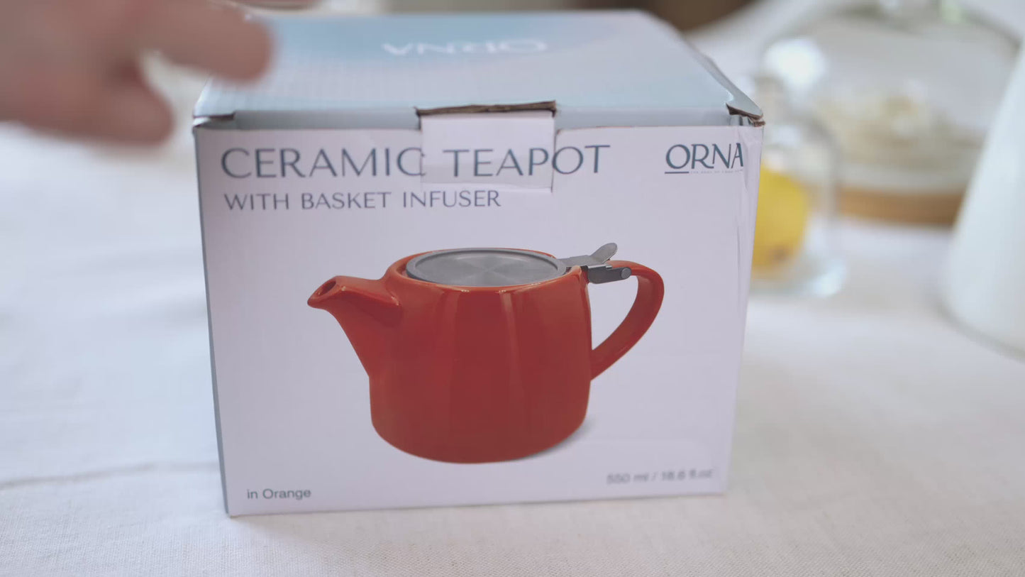 Load and play video in Gallery viewer, ORNA Ceramic Teapot with Basket Infuser and Stainless Steel Lid in Orange, 18.6 Oz (550ml)